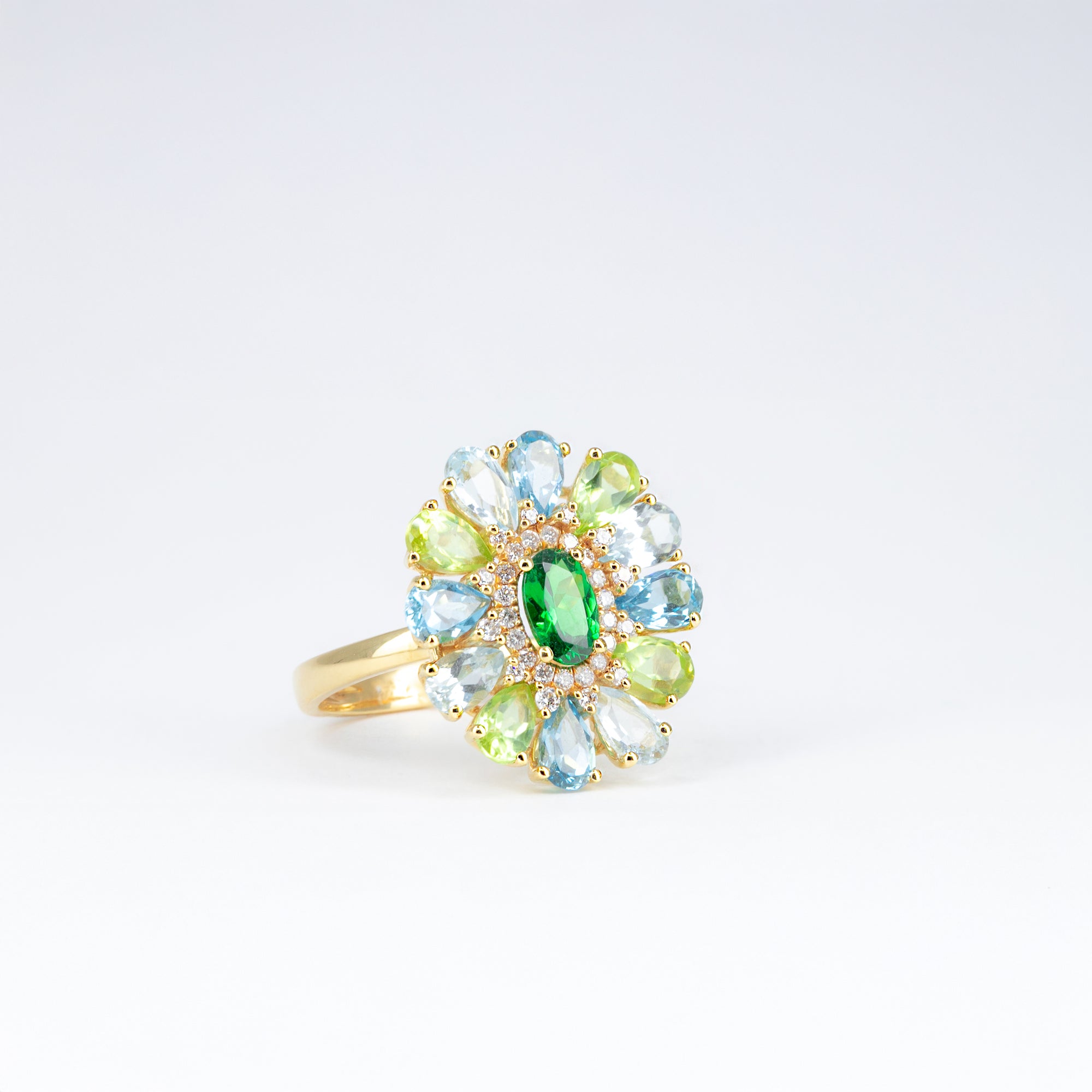 Bague tsavorite, péridots et topazes